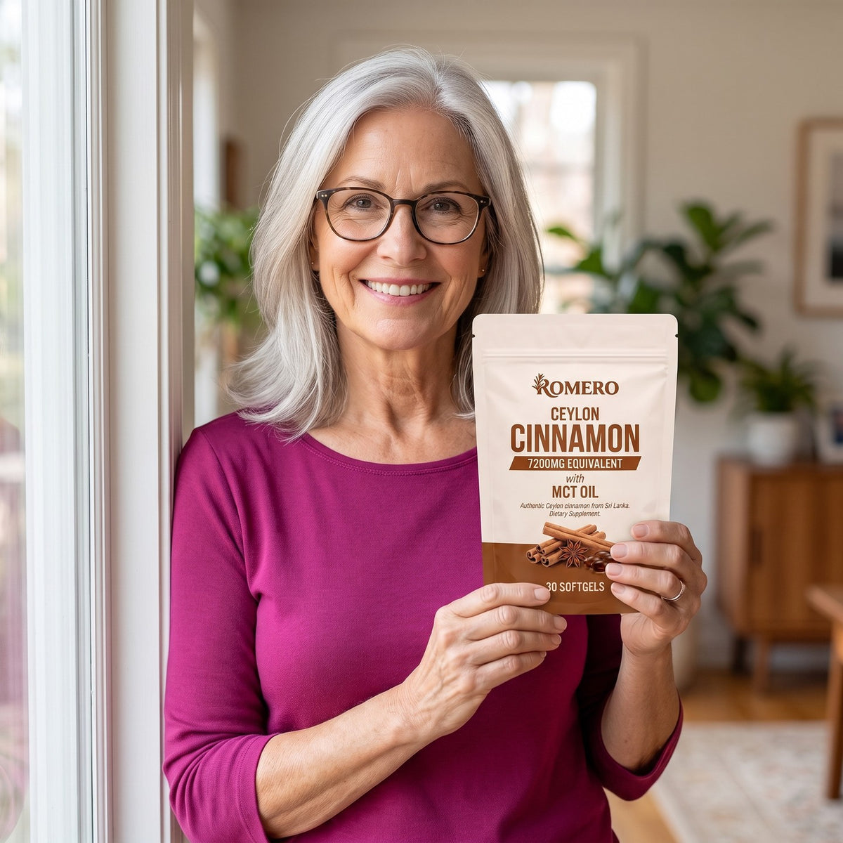 Smiling woman holding a ROMERO Ceylon Cinnamon pouch at home