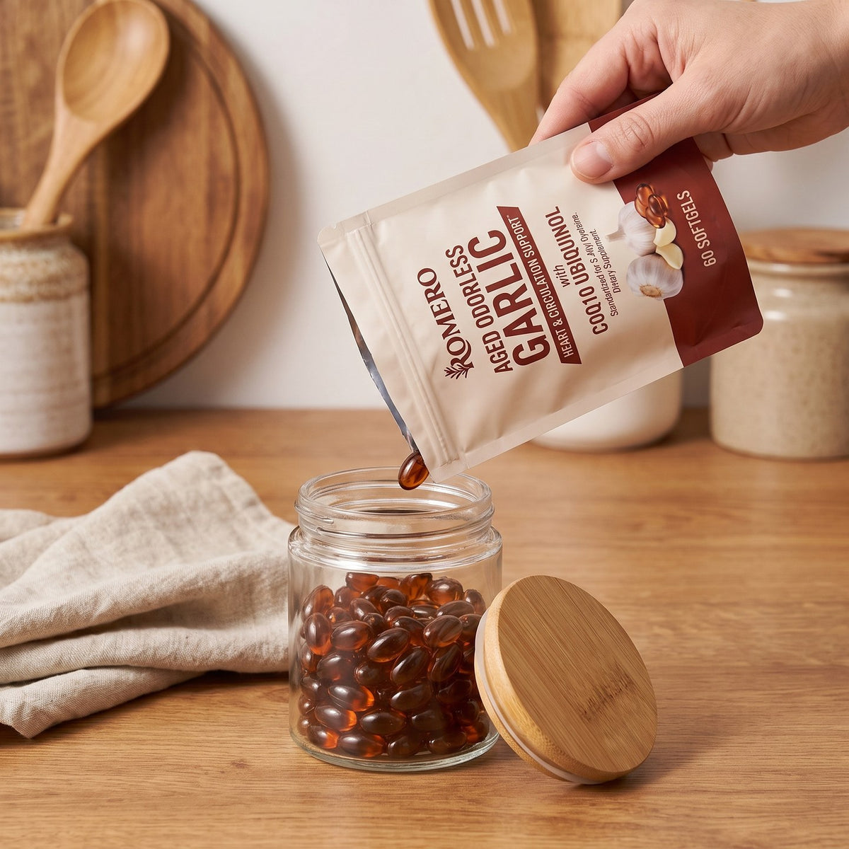 Pouring ROMERO Aged Odorless Garlic softgels from the pouch into a bamboo lid glass jar